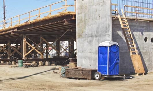 multiple portable restrooms arranged at a busy work site